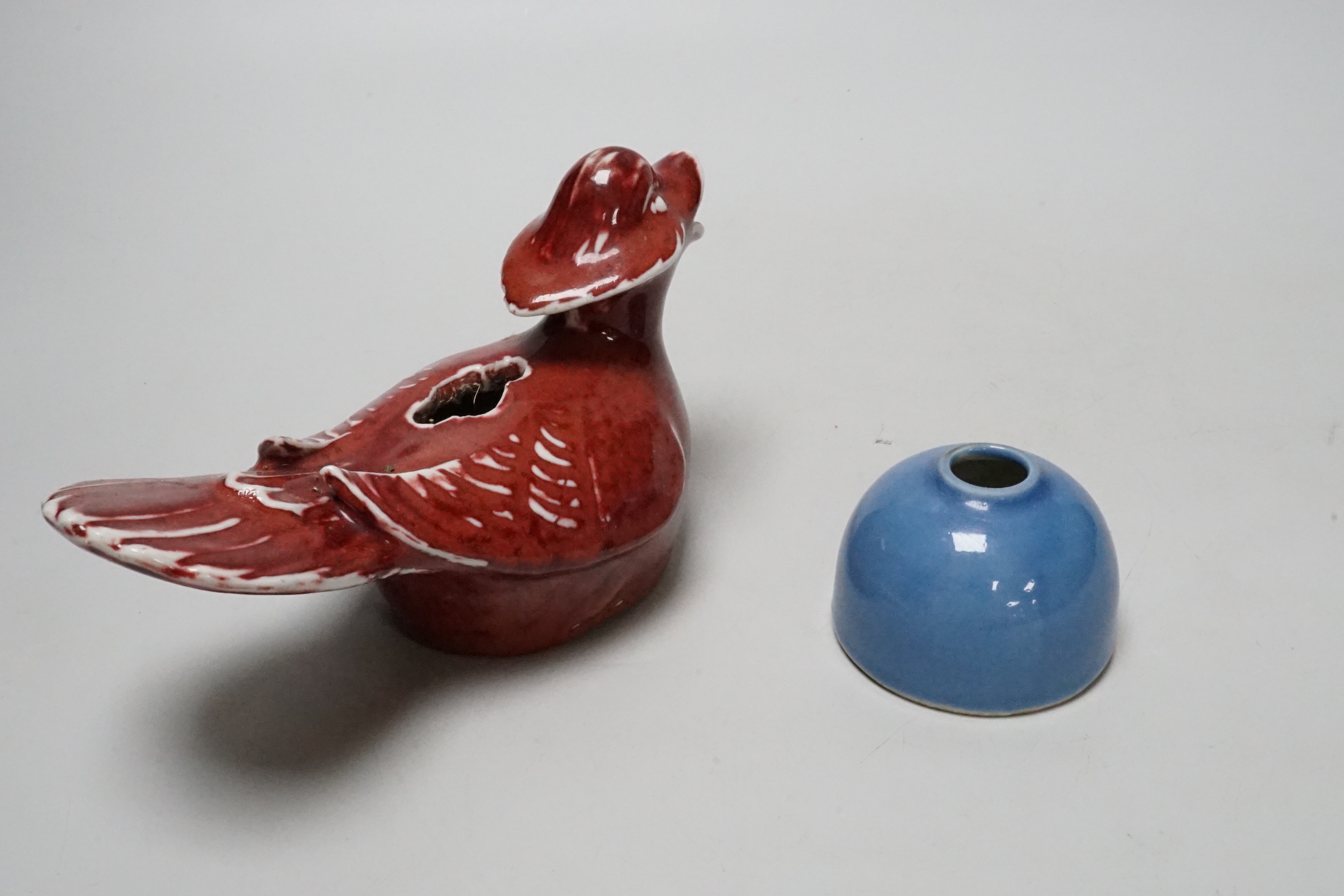 A Chinese sang de boeuf cockerel and blue glazed inkwell, cockerel 18cm wide